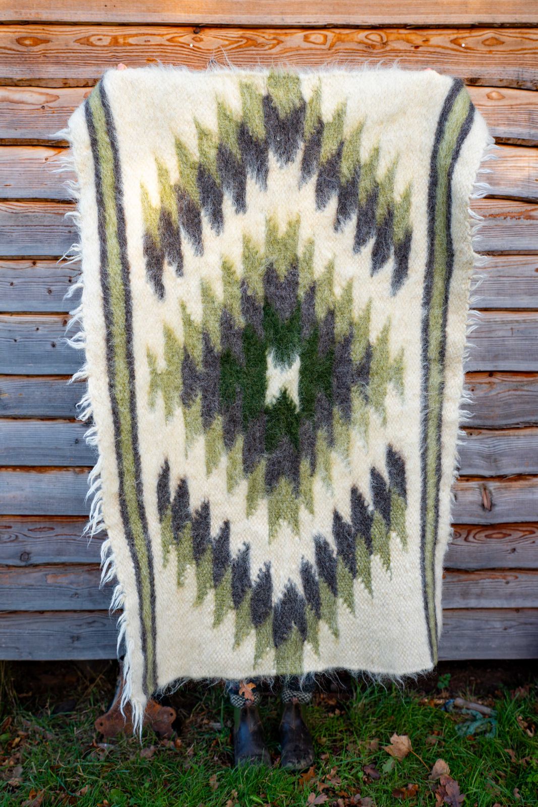 Handwoven wool rug with green diamonds., view 2